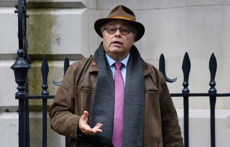 Guiding in Harley Street wearing suit, leather jacket, scarf and pink tie